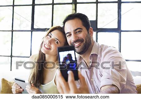 Stock Photography - Couple taking selfie. Fotosearch
