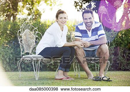Stock Photo - Couple together outdoors, portrait. Fotosearch