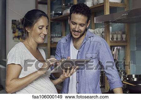 Stock Photo - Couple using digital tablet together. Fotosearch