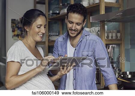 Stock Photo - Couple using digital tablet together. Fotosearch