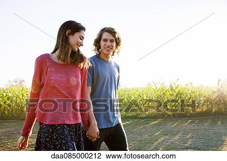 Couple wacking together in countryside View Large Photo Image Stock Image - Couple wacking together in countryside. Fotosearch