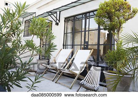 Deckchairs on hotel patio View Large Photo Image Stock Photo - Deckchairs on hotel patio. Fotosearch