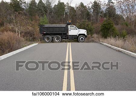 Picture - Dump truck parked at dead end on road. Fotosearch