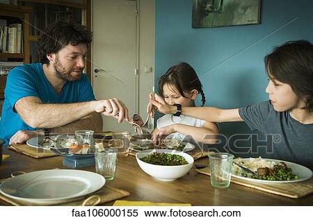 Family eating dinner together View Large Photo Image Stock Photography - Family eating dinner together. Fotosearch