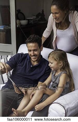 Family using digital tablet together View Large Photo Image Stock Image - Family using digital tablet together. Fotosearch