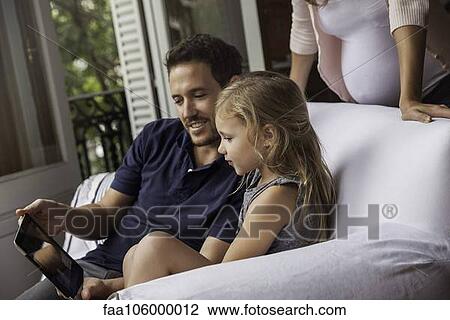 Family using digital tablet together View Large Photo Image Stock Image - Family using digital tablet together. Fotosearch
