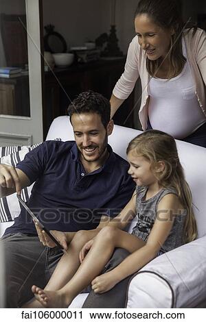 Family using digital tablet together View Large Photo Image Stock Image - Family using digital tablet together. Fotosearch