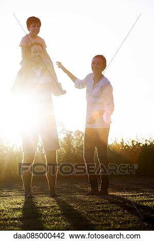 Family with little boy having fun at the park View Large Photo Image Stock Image - Family with little boy having fun at the park. Fotosearch