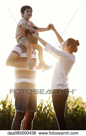 Stock Photo - Family with little boy having fun at the park. Fotosearch