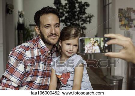 Father and daughter posing for photo View Large Photo Image Stock Image - Father and daughter posing for photo. Fotosearch