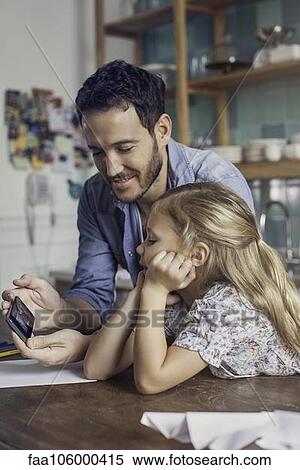 Father and daughter spending time at home together View Large Photo Image Stock Photography - Father and daughter spending time at home together. Fotosearch
