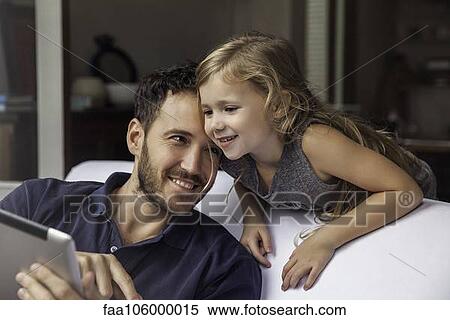 Father and daughter using digital tablet together View Large Photo Image Stock Photography - Father and daughter using digital tablet together. Fotosearch