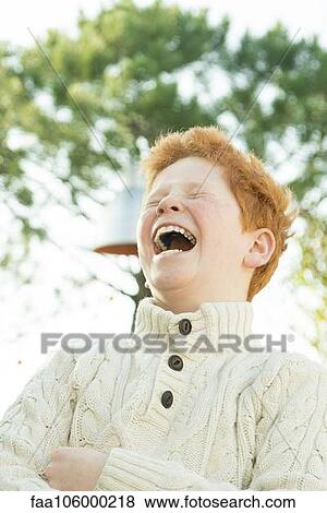 Father and son laughing together outdoors View Large Photo Image Stock Photo - Father and son laughing together outdoors. Fotosearch