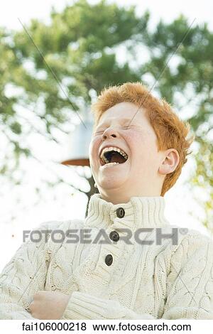 Father and son laughing together outdoors View Large Photo Image Stock Photo - Father and son laughing together outdoors. Fotosearch