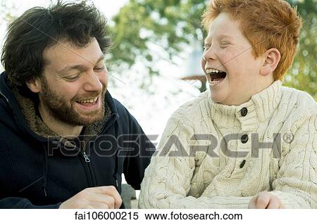 Father and son laughing together outdoors View Large Photo Image Stock Photography - Father and son laughing together outdoors. Fotosearch