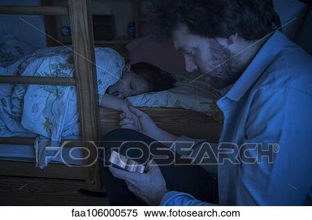 Father checking smartphone while comforting sick daughter View Large Photo Image Stock Photography - Father checking smartphone while comforting sick daughter. Fotosearch