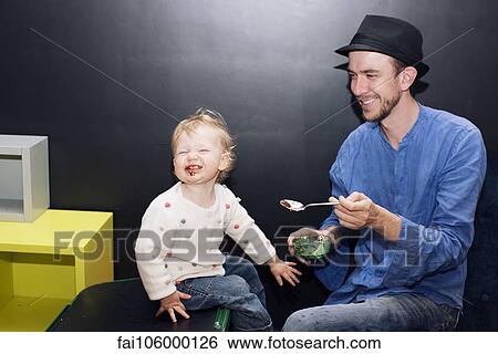 Father feeding toddler ice cream View Large Photo Image Stock Photograph - Father feeding toddler ice cream. Fotosearch