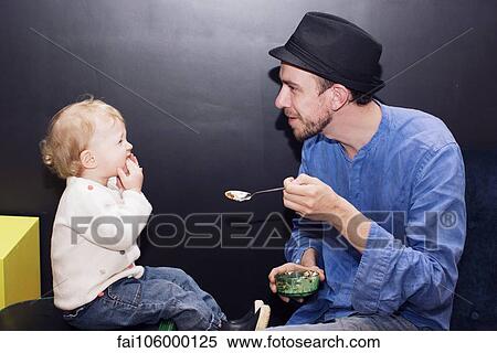 Father feeding toddler View Large Photo Image Stock Photography - Father feeding toddler. Fotosearch