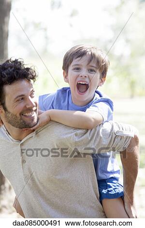 Father giving little boy piggyback ride View Large Photo Image Stock Image - Father giving little boy piggyback ride. Fotosearch