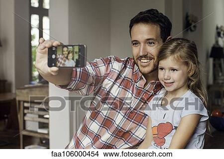 Father posing for selfie with daughter View Large Photo Image Picture - Father posing for selfie with daughter. Fotosearch