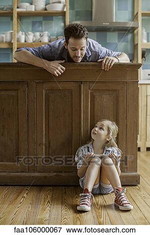 Father wanting to spend time with daughter distracted by video game View Large Photo Image Stock Photo - Father wanting to spend time with daughter distracted by video game. Fotosearch