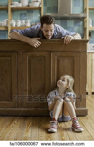 Stock Photo - Father wanting to spend time with daughter distracted by video game. Fotosearch