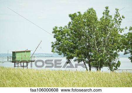 Fishing hut on stilts near water's edge View Large Photo Image Stock Photo - Fishing hut on stilts near water's edge. Fotosearch