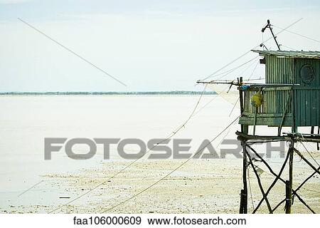 Fishing hut on stilts near water's edge View Large Photo Image Stock Photo - Fishing hut on stilts near water's edge. Fotosearch