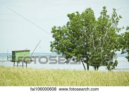 Fishing hut on stilts near water's edge View Large Photo Image Stock Photo - Fishing hut on stilts near water's edge. Fotosearch