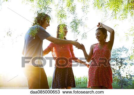 Friends dancing outdoors View Large Photo Image Stock Image - Friends dancing outdoors. Fotosearch