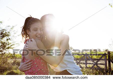 Friends embracing, portrait View Large Photo Image Picture - Friends embracing, portrait. Fotosearch