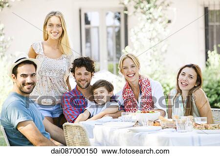 Friends enjoying meal together outdoors View Large Photo Image Stock Image - Friends enjoying meal together outdoors. Fotosearch