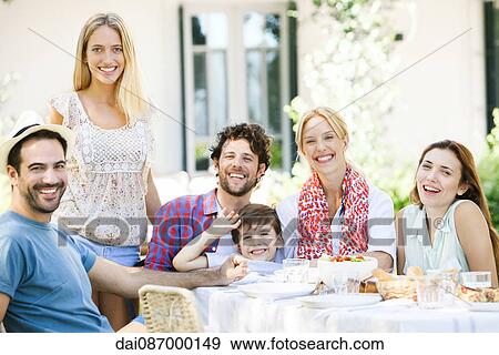 Friends enjoying meal together outdoors View Large Photo Image Stock Photo - Friends enjoying meal together outdoors. Fotosearch