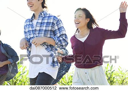 Friends having lighthearted moment together outdoors View Large Photo Image Stock Image - Friends having lighthearted moment together outdoors. Fotosearch