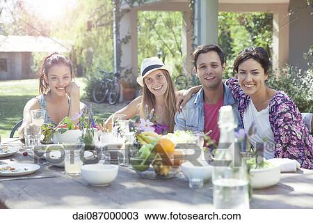 Friends having meal together, portrait View Large Photo Image Stock Image - Friends having meal together, portrait. Fotosearch