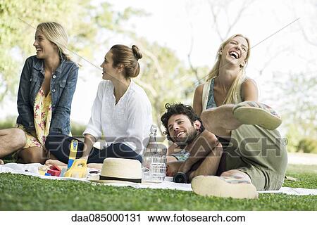 Friends picnicking in park View Large Photo Image Stock Image - Friends picnicking in park. Fotosearch