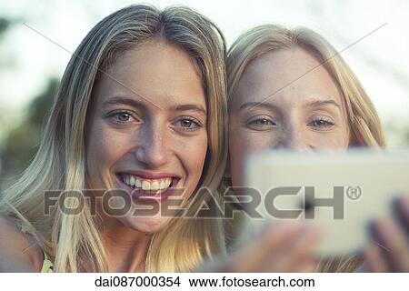 Friends posing for smartphone selfie View Large Photo Image Picture - Friends posing for smartphone selfie. Fotosearch