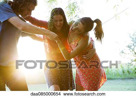 Friends spending carefree afternoon together outdoors View Large Photo Image Picture - Friends spending carefree afternoon together outdoors. Fotosearch