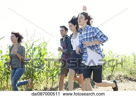 Stock Image - Friends spending fun time together outdoors. Fotosearch