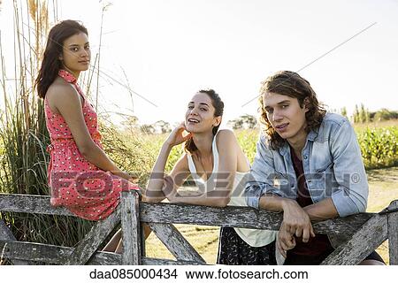 Friends spending lazy day together outdoors View Large Photo Image Picture - Friends spending lazy day together outdoors. Fotosearch