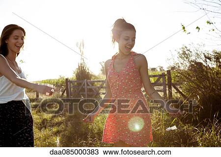 Friends spending lighthearted afternoon together outdoors View Large Photo Image Stock Image - Friends spending lighthearted afternoon together outdoors. Fotosearch