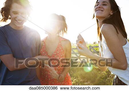 Friends spending lighthearted day together outdoors View Large Photo Image Stock Photograph - Friends spending lighthearted day together outdoors. Fotosearch