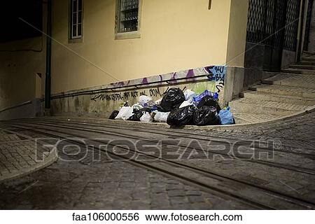 Garbage on side of cobblestone street View Large Photo Image Stock Photograph - Garbage on side of cobblestone street. Fotosearch