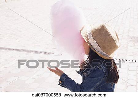 Girl eating cotton candy View Large Photo Image Stock Photo - Girl eating cotton candy. Fotosearch