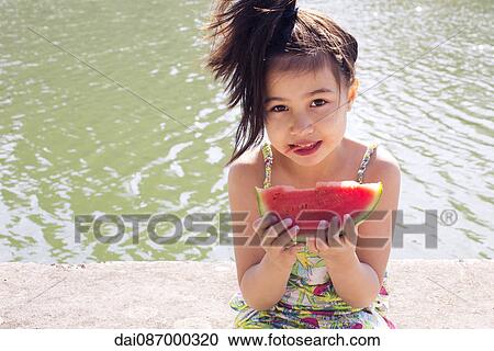 Girl eating watermelon, portrait View Large Photo Image Stock Image - Girl eating watermelon, portrait. Fotosearch