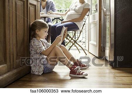 Girl engrossed in video streaming on digital tablet View Large Photo Image Stock Image - Girl engrossed in video streaming on digital tablet. Fotosearch