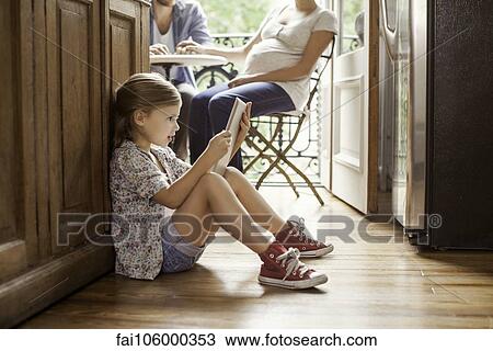 Girl engrossed in video streaming on digital tablet View Large Photo Image Stock Image - Girl engrossed in video streaming on digital tablet. Fotosearch