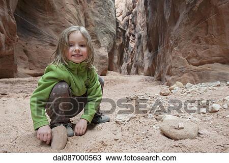 Girl looking at rocks, portrait View Large Photo Image Stock Image - Girl looking at rocks, portrait. Fotosearch