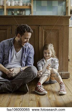 Girl showing father digital tablet View Large Photo Image Stock Photography - Girl showing father digital tablet. Fotosearch