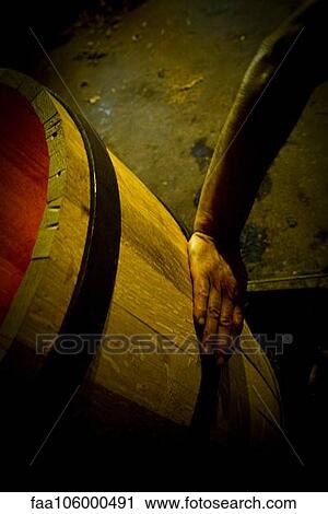 Stock Image - Hand touching wooden cask. Fotosearch